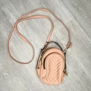 Pink mini purse with gold zipper and accents.